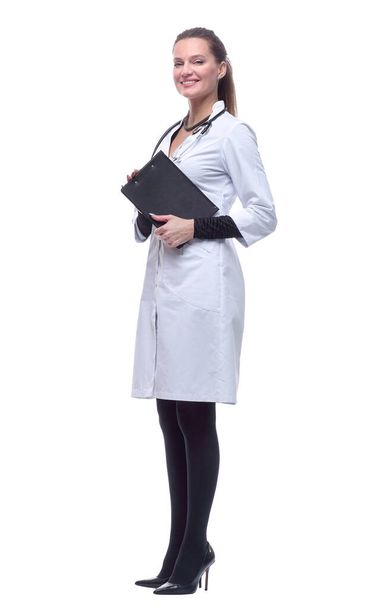 in full growth. female doctor with clipboard striding forward. - Φωτογραφία, εικόνα