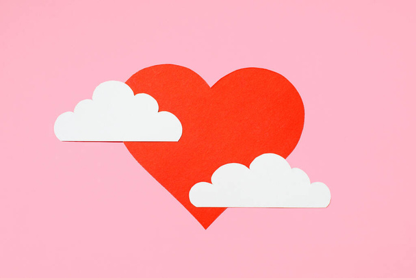 Valentine's Day concept. Red heart in the clouds on a pastel pink background. Greeting card design. Flat lay, top view, copy space - Foto, Bild