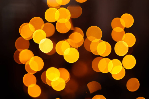 Bokeh. garland lights on a dark background. Christmas decoration.  - Φωτογραφία, εικόνα