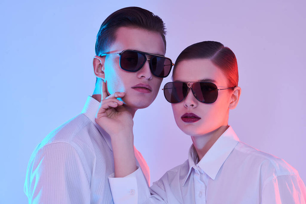 Glasses fashion. Portrait of a fashion models posing in white shirts and modern sunglasses. Studio shot. - Fotografie, Obrázek