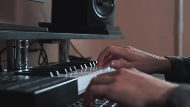 Male hands playing electronic keyboard, midi keys on the table. - Footage, Video