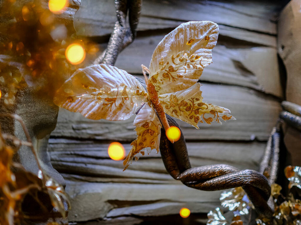 Shimmering golden and yellow Christmas butterfly with colorful lights. High quality photo - Photo, Image