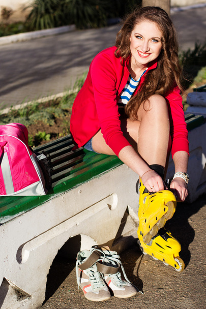 Pretty teenage girl with yellow roller-skates - Foto, afbeelding