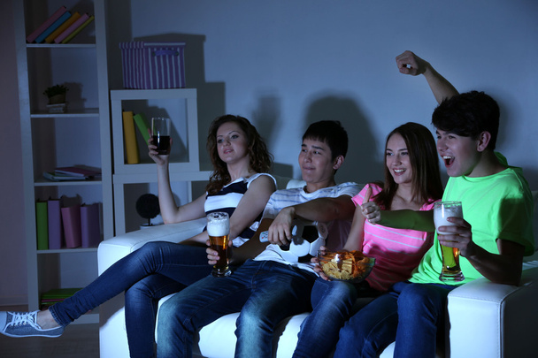 Group of young friends watching television at home of blacking-out - Foto, Bild