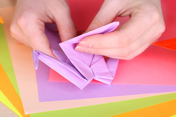 Hands making origami crane, close up - Фото, изображение
