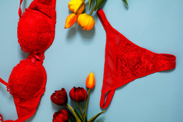 retro colorful minimalist photo of sexy women lace underwear and tulips on bright blue background - Photo, Image