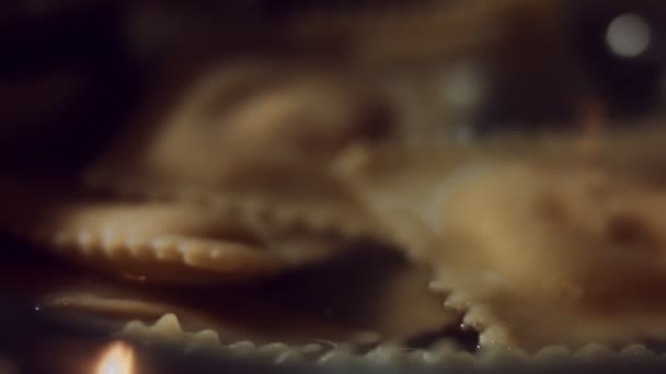 Macro view of ravioli cooking in a pan with hot water. Preparing ravioli, a typical Italian dish, homemade according to the ancient Italian tradition. 4K video - Footage, Video