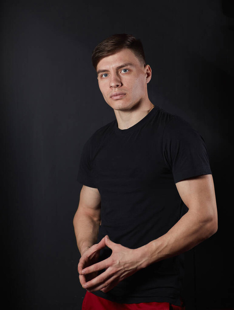 Handsome young muscular man looking at camera in studio shot over neutral background - Zdjęcie, obraz