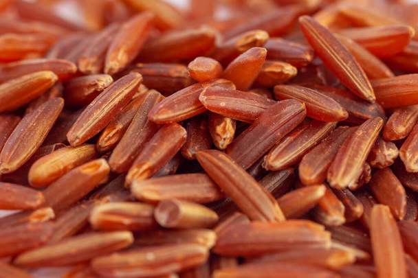 Texture of raw long grains of red rice, healthy food - Fotó, kép