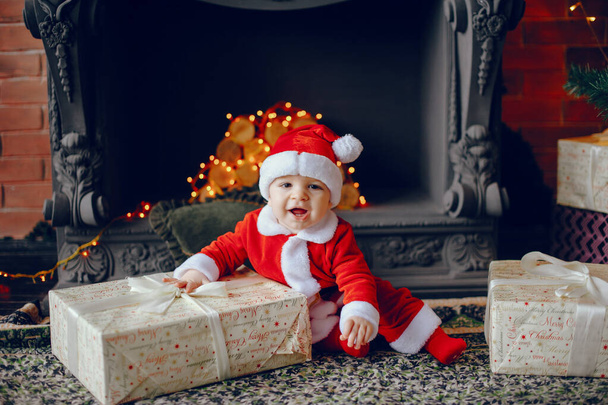 Cutte little boy at home near christmas decorations - Φωτογραφία, εικόνα