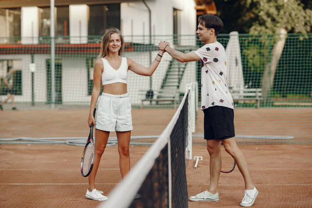  ouple play tennis game outdoor - Fotoğraf, Görsel