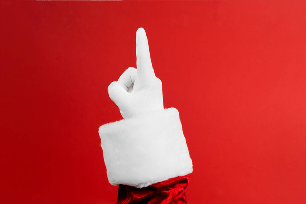 Photo of Santa Claus gloved hands in pointing gesture. - Fotó, kép