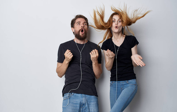 young couple in headphones technology music fun studio isolated background - Photo, Image