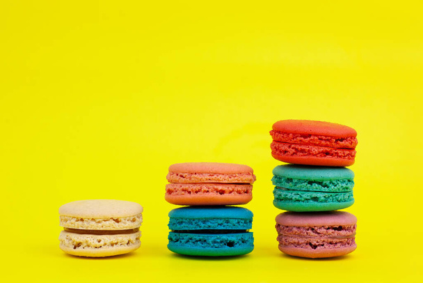 French colorful macarons on a yellow background.Dessert, sweets - Foto, immagini