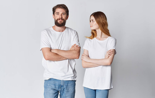 couple in love man and woman in the same t-shirt friends light background - Foto, Imagen