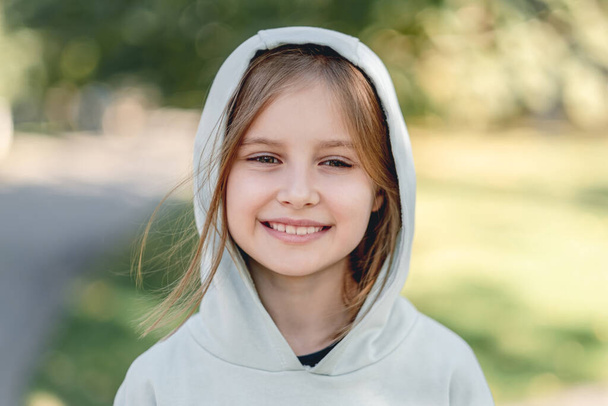 Portrait of happy little girl in hoodie - Фото, изображение
