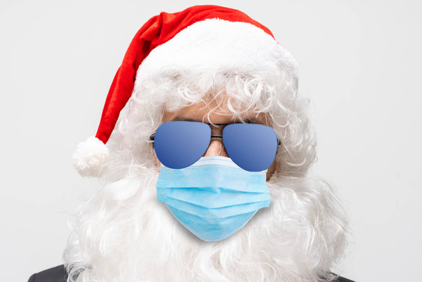 Hello kids. Closeup photo old bearded happy santa talk children remote internet online facial webcam view work wear respirator mask headwear shirt suspenders isolated red background - Photo, Image