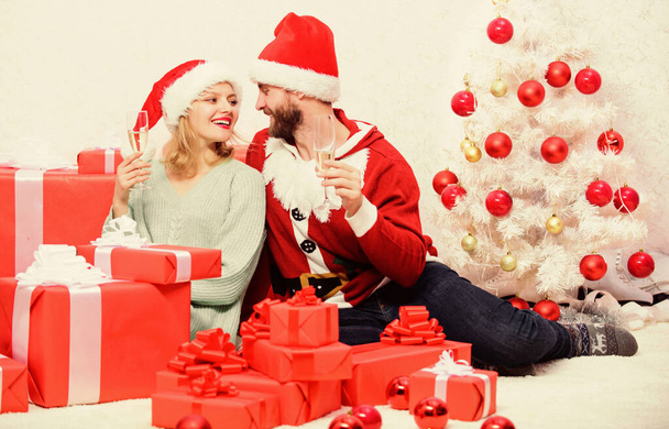 Happy new year and merry christmas. Celebrating christmas together. Loving couple cuddle and drink champagne near christmas tree. Couple in love enjoy christmas holiday celebration. Family tradition - Фото, изображение