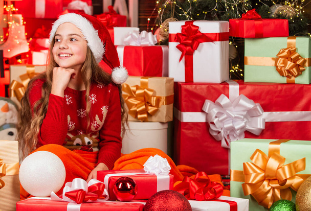 cute playful christmas elf. little girl red santa hat. santa claus residence. present delivery service. too much gifts. big sale at holiday shopping. gift shop. happy winter. Santaland Diaries - Φωτογραφία, εικόνα