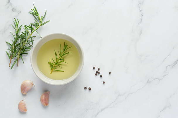 Oil with rosemary on table - Фото, изображение