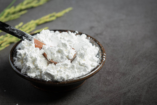 white rice flour on small bowl with rice plant - Valokuva, kuva