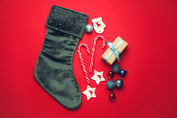 Composition with Christmas sock on color background - Photo, Image
