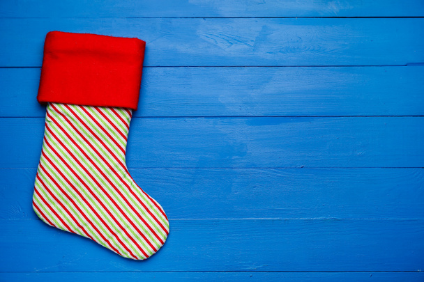 Striped Christmas sock on color background - Photo, Image