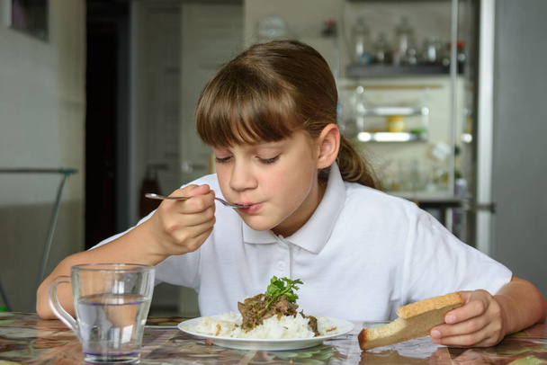 女の子は昼食のために第二皿を食べる - 写真・画像