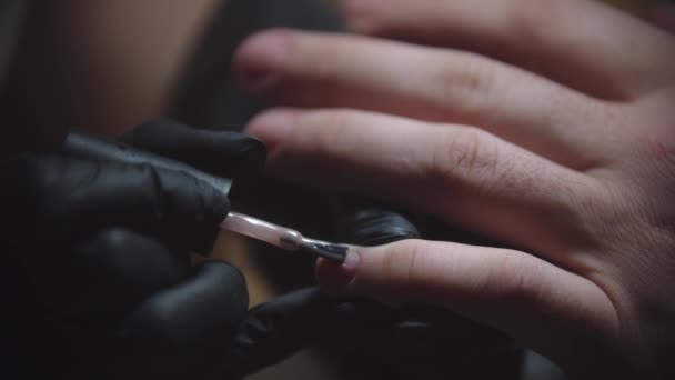 Male manicure - the nail master applying natural nail polish on the nail plate - Footage, Video