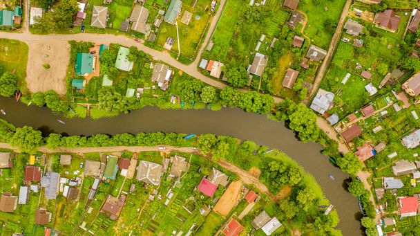 top view of a beautiful holiday village, which is crossed by a crooked river - Fotó, kép