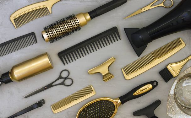 Background with gold and black hair salon accessories. Hairdressers tools, Wallpaper in trendy gray and yellow colors. - Foto, Imagem