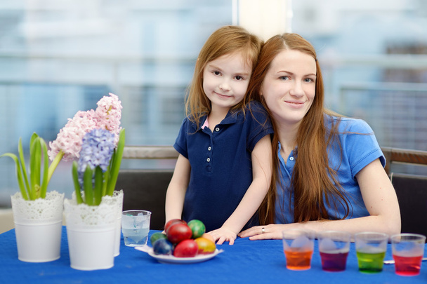 Mother and her daughter painting Easter eggs - Photo, image