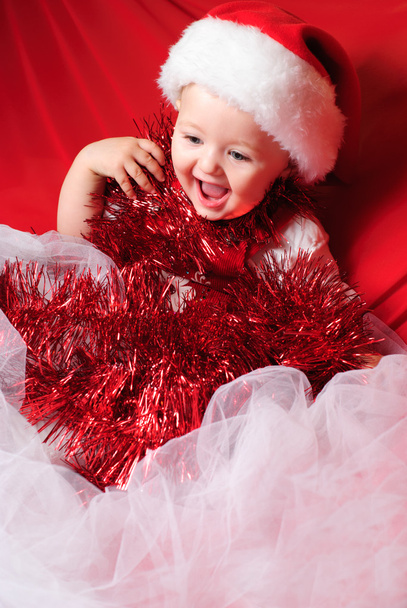 Girl santa on red cloth - Valokuva, kuva