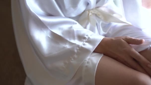 Uma mulher em um manto de seda senta-se à janela, close-up - Filmagem, Vídeo