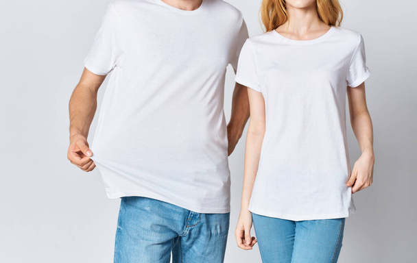 man and woman in white t-shirts and jeans fashionable style clothes - Foto, immagini