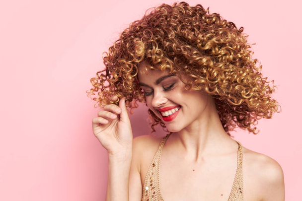 Model curly hair look down studio pink background  - Foto, imagen