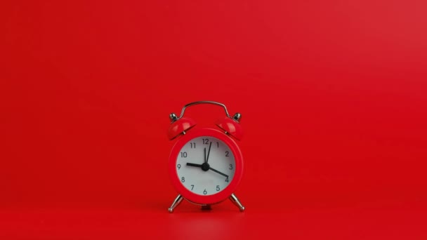 Vintage alarm clock on a red background. - Footage, Video