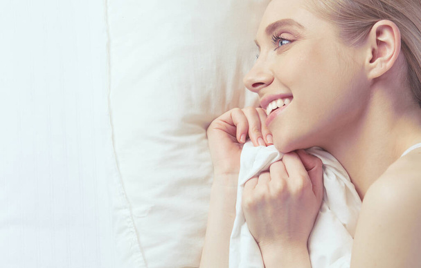 Photo of sleeping young woman lying in bed with eyes closed - Photo, image