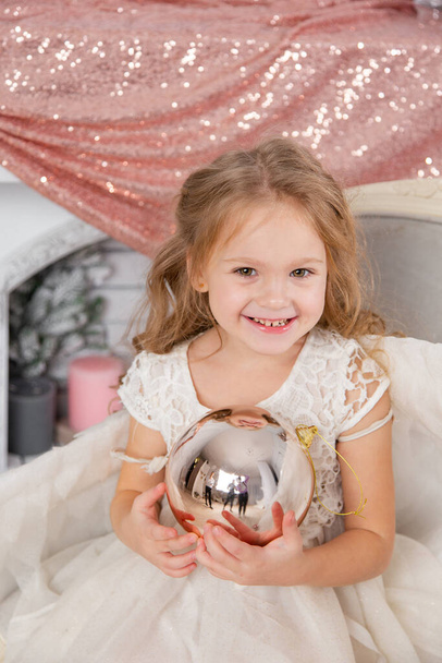 Christmas shooting of a cute little girl in the studio with wings - 写真・画像