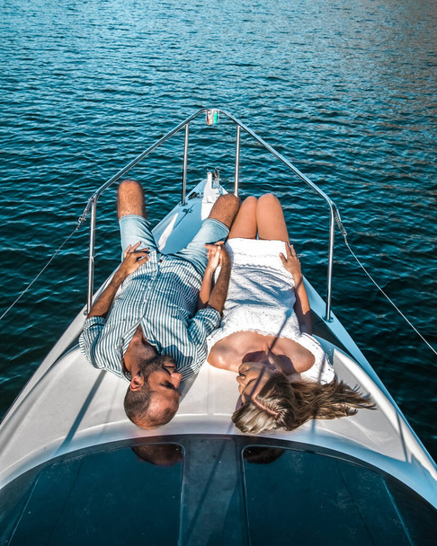 Young couple on on a yacht cruise through Douro river in Portugal - Photo, Image
