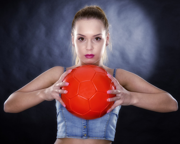 Woman with soccer ball isolated on black background - Photo, Image