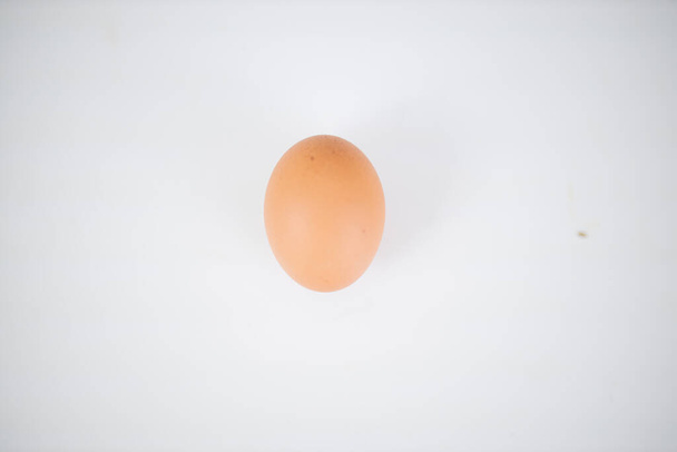 Egg isolated on a white table from above - Photo, Image