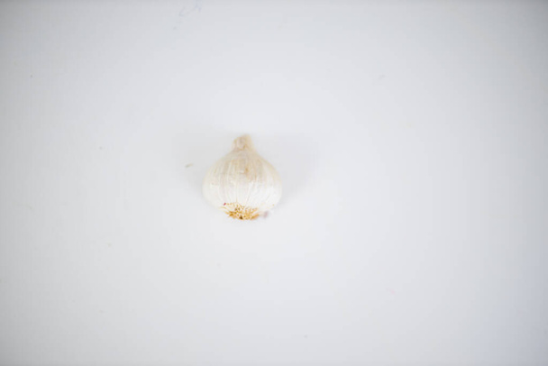 Friss fokhagyma izolálva egy fehér asztalon felülről - Fotó, kép