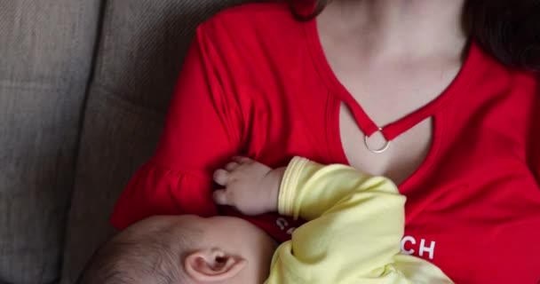 mother breastfeeding baby at home. motherhood and maternity care concept. Cheerful mom enjoy breastfeeding - Footage, Video