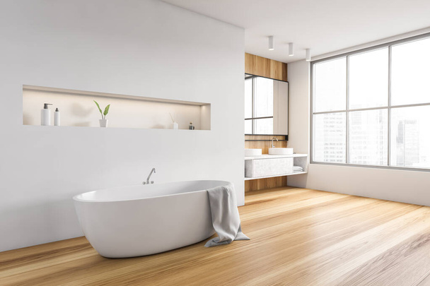 Wooden and white bathroom with bathtub with towel, side view, large window with city view. Minimalist design of modern white bathroom with wooden floor 3D rendering, no people - Fotó, kép