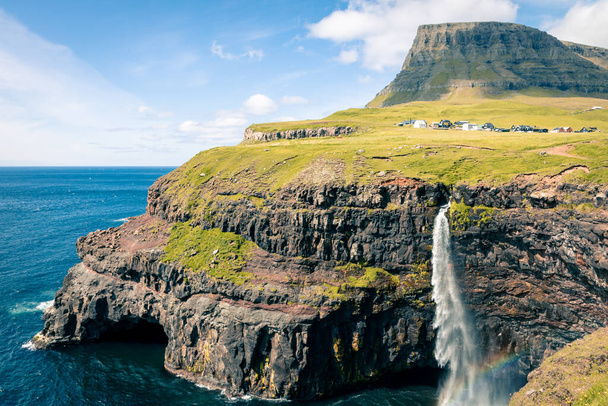 Faroes. Mulafossur waterfall in Gasadalur village in Faroe Islands, North Atlantic Ocean. Nordic Natural Landscape. - Photo, Image