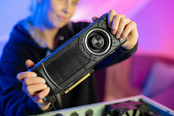 Gamer Girl Holding a New GPU Video Card in Her Hands - Photo, image