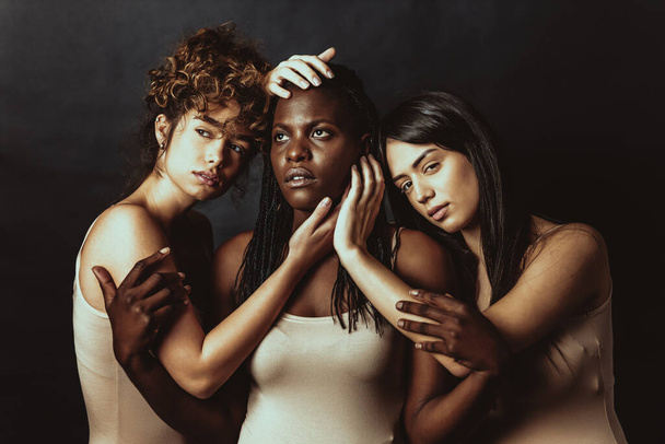 Multicultural group of beautiful women posing in underwear - 3 pretty girls portrait, concepts about multicultural people, inclusive society and body positivity - Foto, imagen