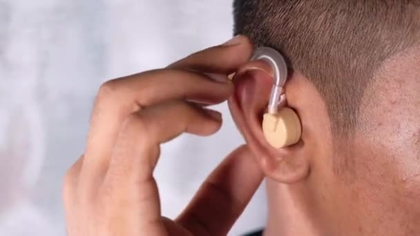 Hearing aid concept, a young man with hearing problems. - Footage, Video