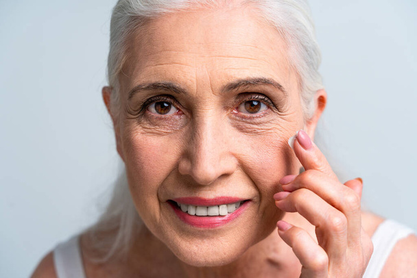 Beautiful senior woman portrait, studio shot on background  - Elderly person, half body shot - Фото, изображение